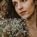 Long-Distance - A woman holding a bunch of flowers in her hand