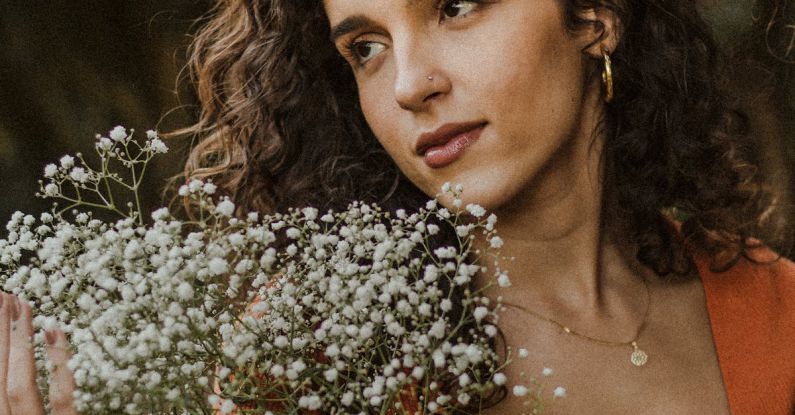 Long-Distance - A woman holding a bunch of flowers in her hand