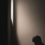 Reading - A Man Reading Book while Sitting on a Bed