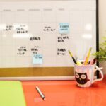 Schedules - A Desk Calendar with Notes and Post Its on Orange Desk