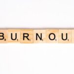 Burnout - Close-Up Shot of Scrabble Tiles on a White Surface