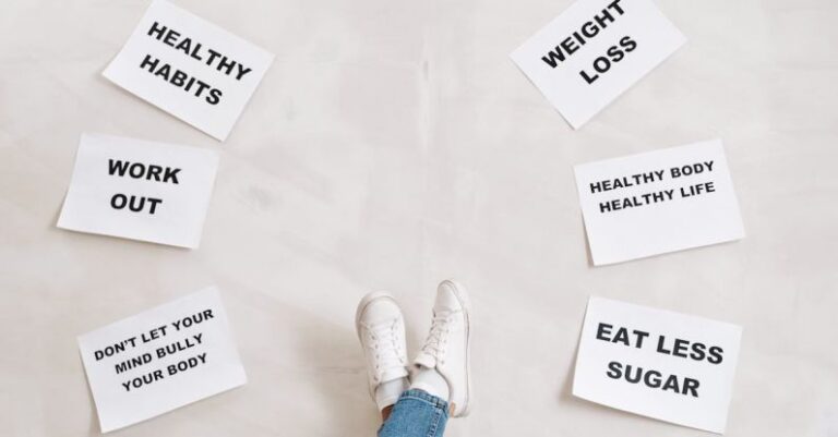 Habits - Person Legs with Motivational Words on Papers on White Background