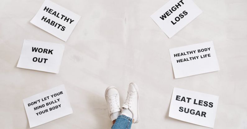 Habits - Person Legs with Motivational Words on Papers on White Background
