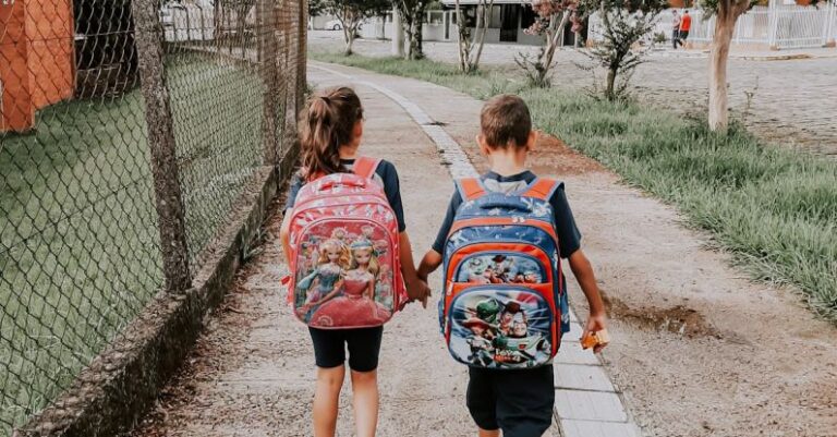 Friendships - Back View of a Little Boy and Girl Walking and Holding Hands