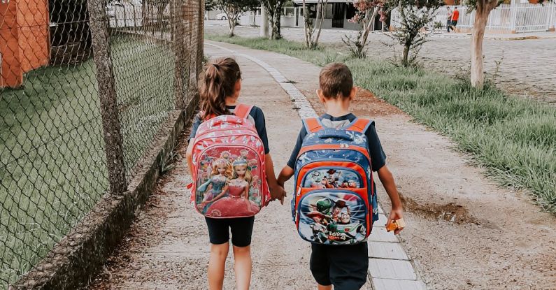 Friendships - Back View of a Little Boy and Girl Walking and Holding Hands